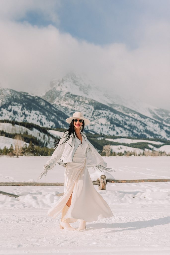 bride dances in front of mountains