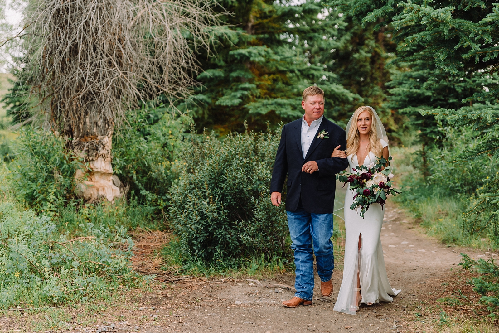 Father walks daughter down the aisle in outdoor wedding ceremony