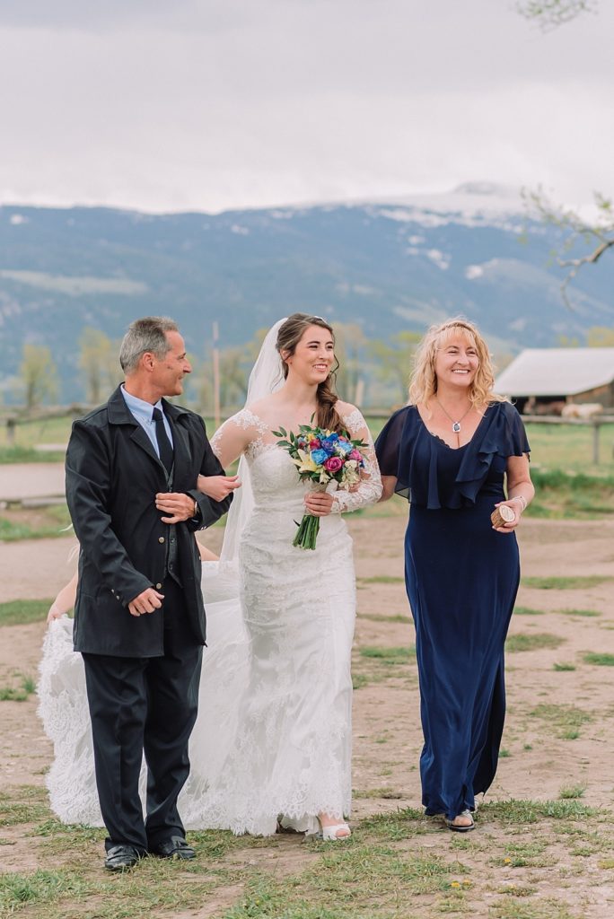 Mom and dad walk bride into wedding ceremony, Mormon Row Spring Wedding