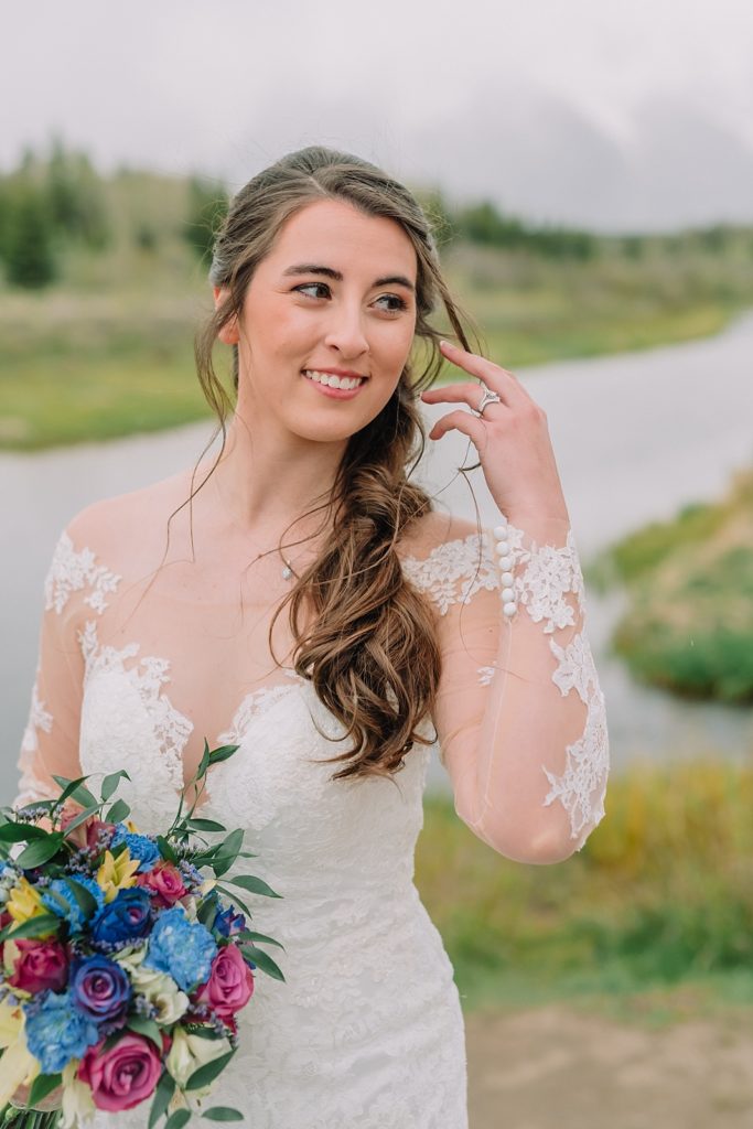 bride with wedding bouquet in front of the mountains, schwabacher's landing wedding