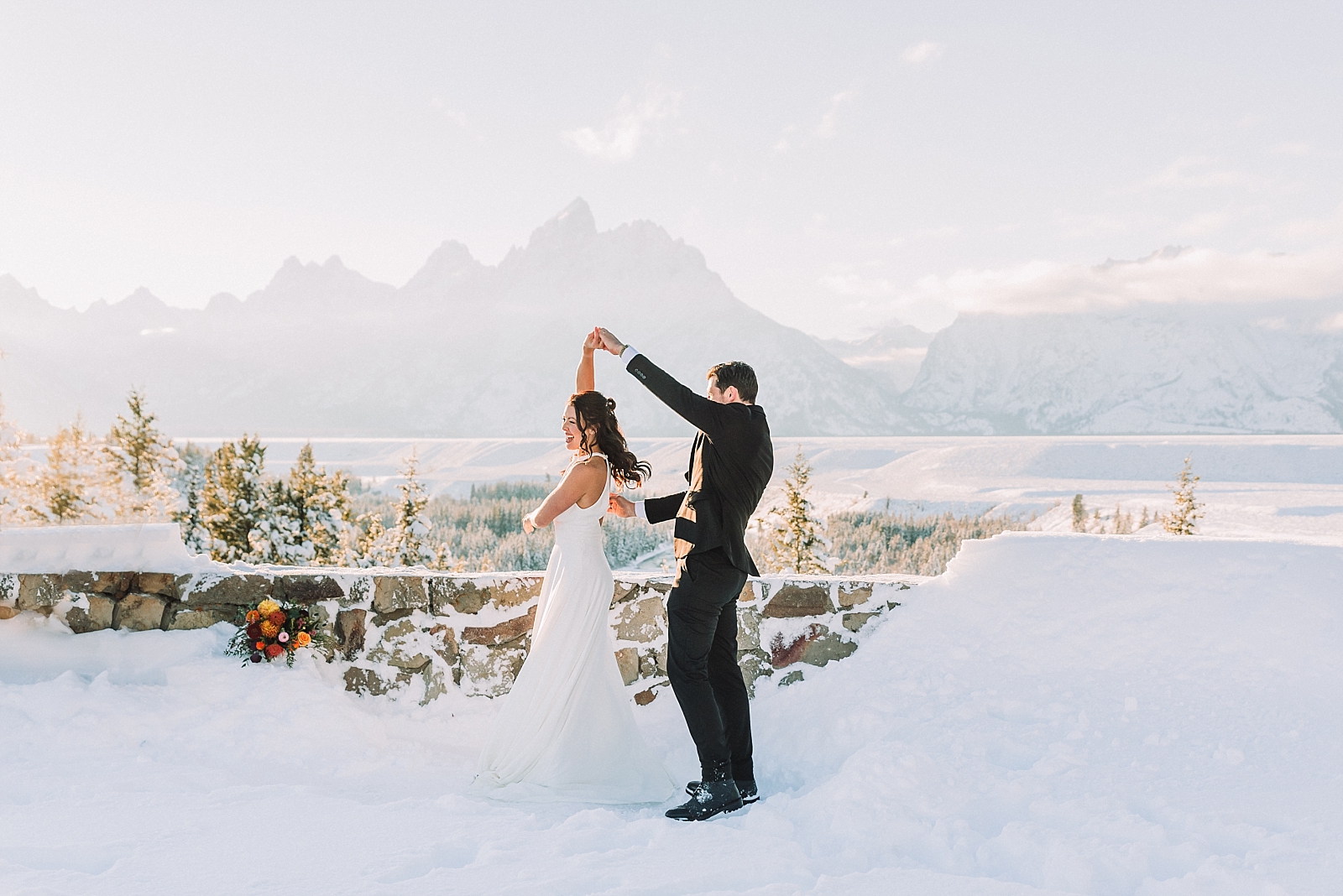 bride and groom dance in winter wedding in the tetons
