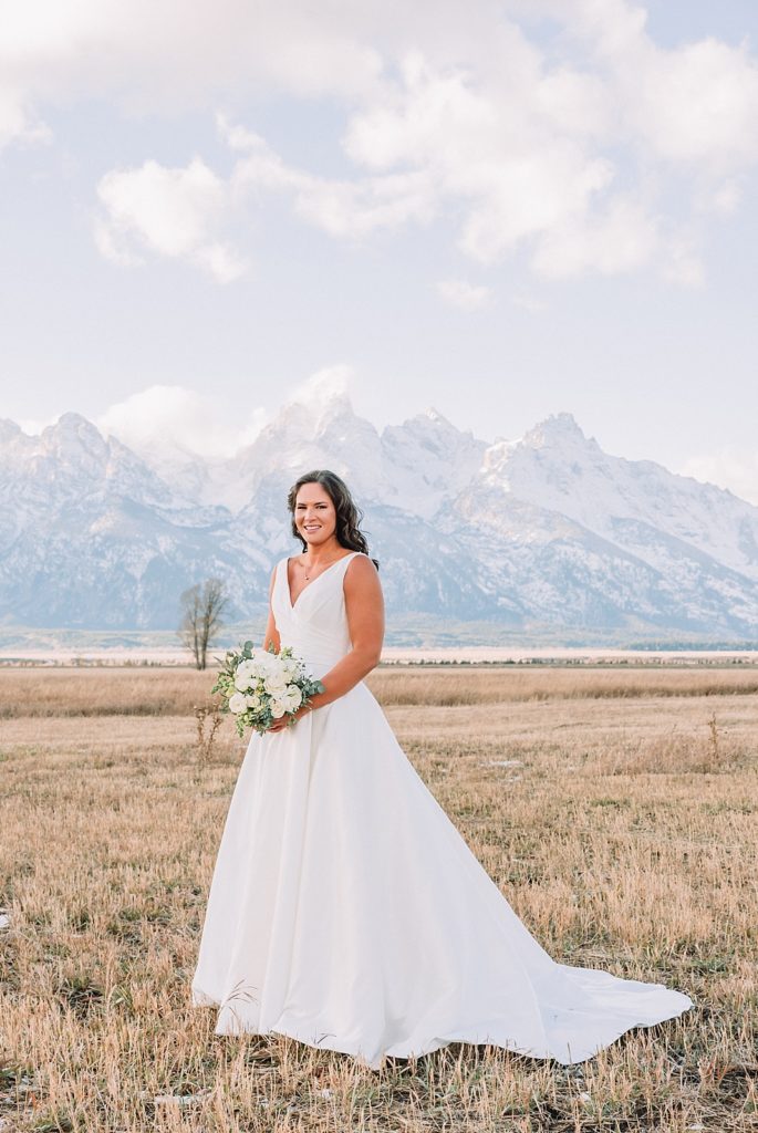bride wedding photos in field with mountains