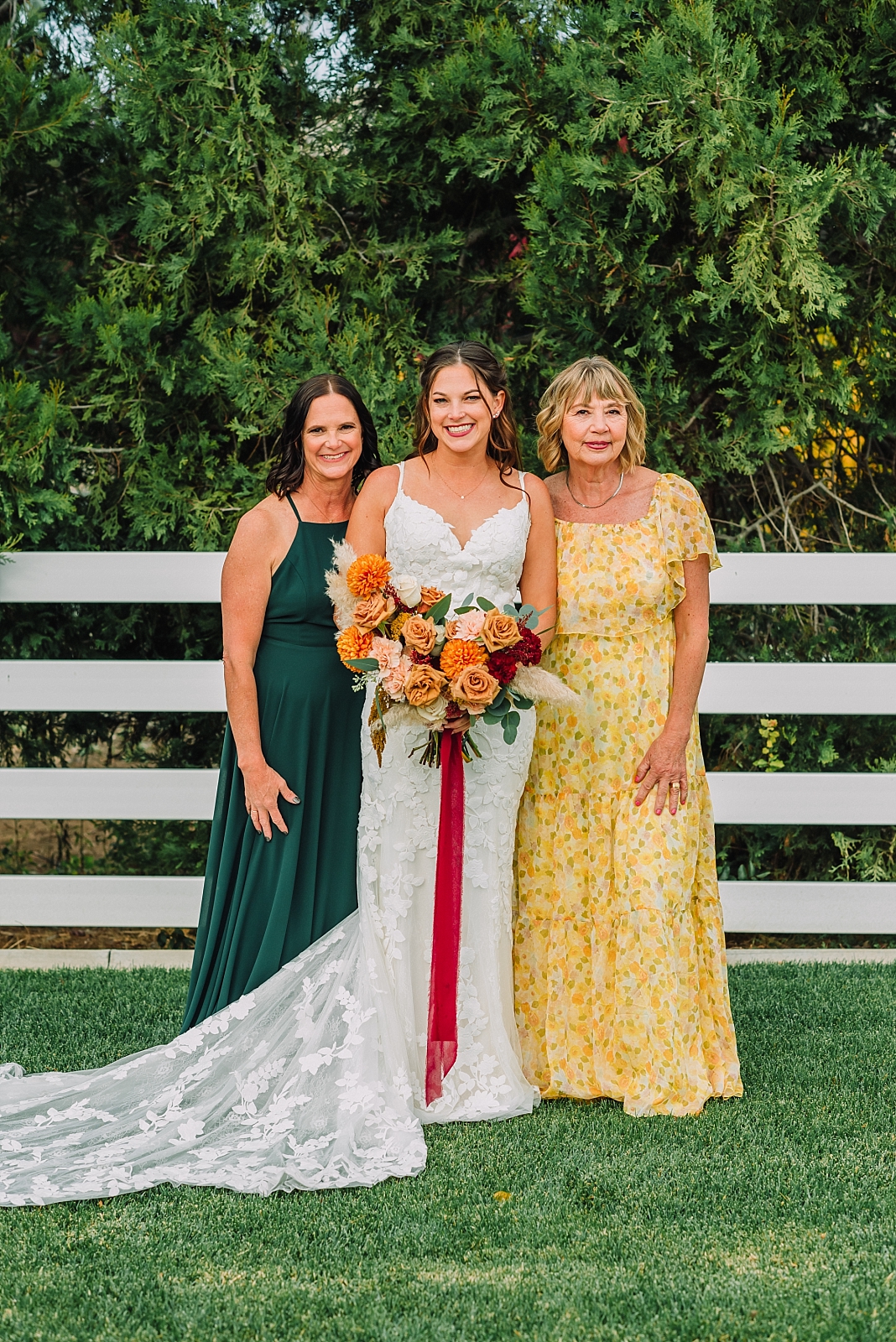 bride, mom, and mother in law on wedding day