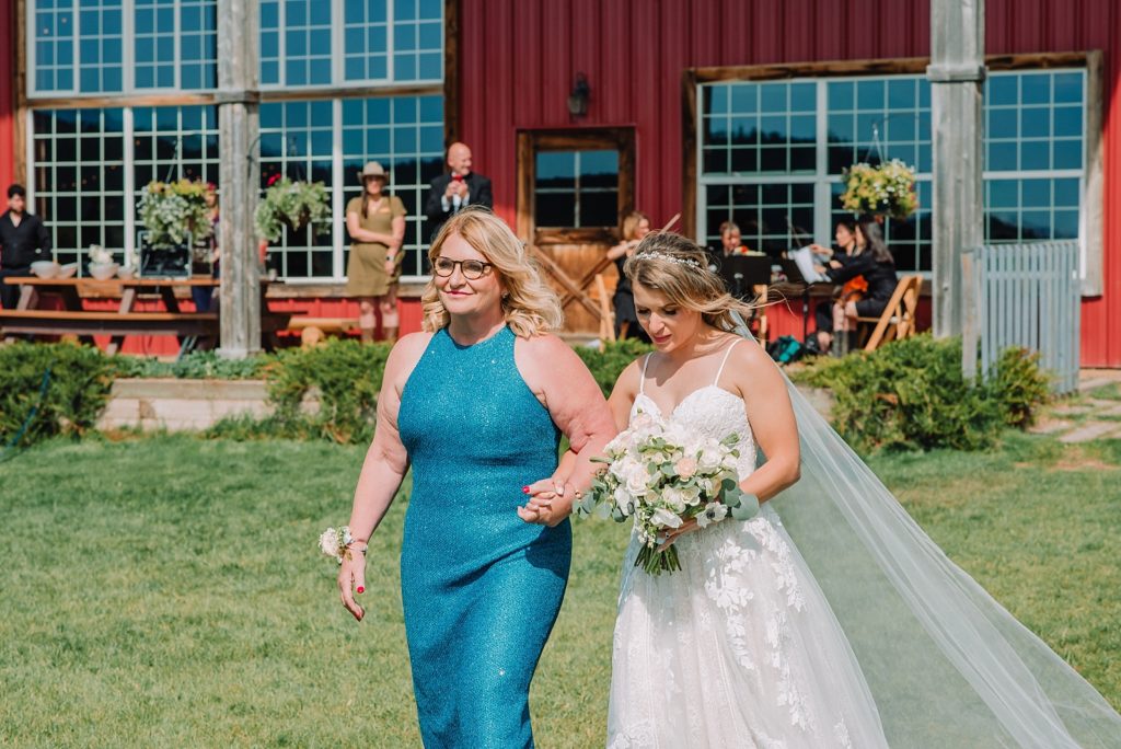 mother walks daughter down the aisle on her wedding day