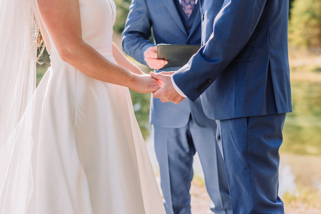 couple holds hands during wedding ceremony, dreamy wedding details