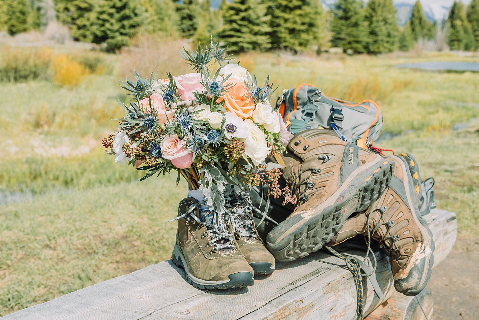 bride and groom backpacking gear and bouquet with wedding flowers