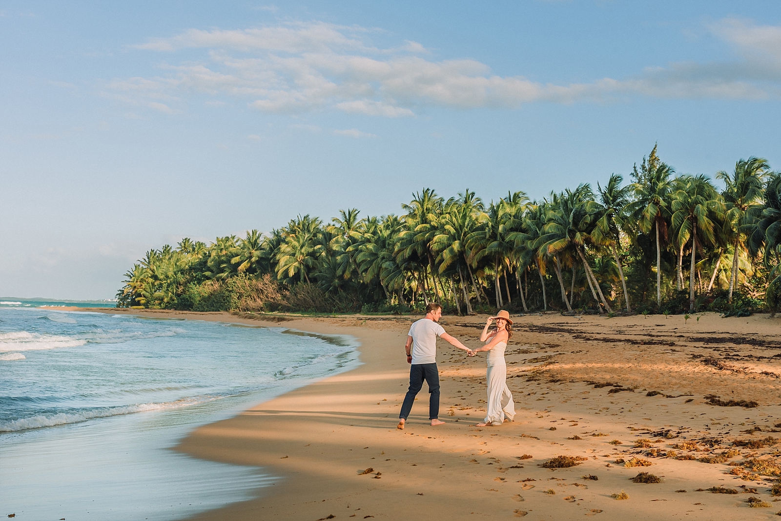 couple walks along the beach in puerto rico