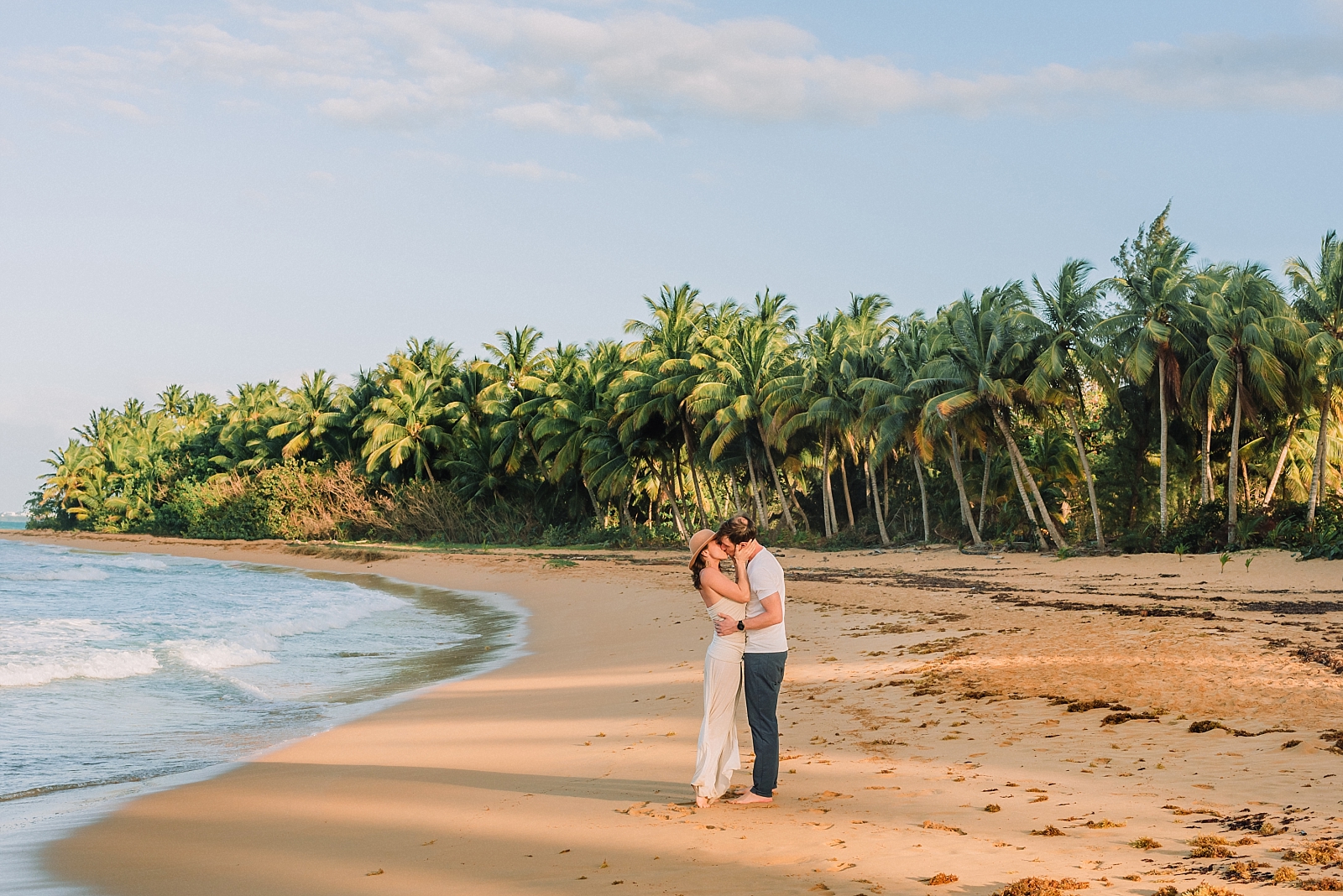 couple kisses on the beach in luquillo puerto rico