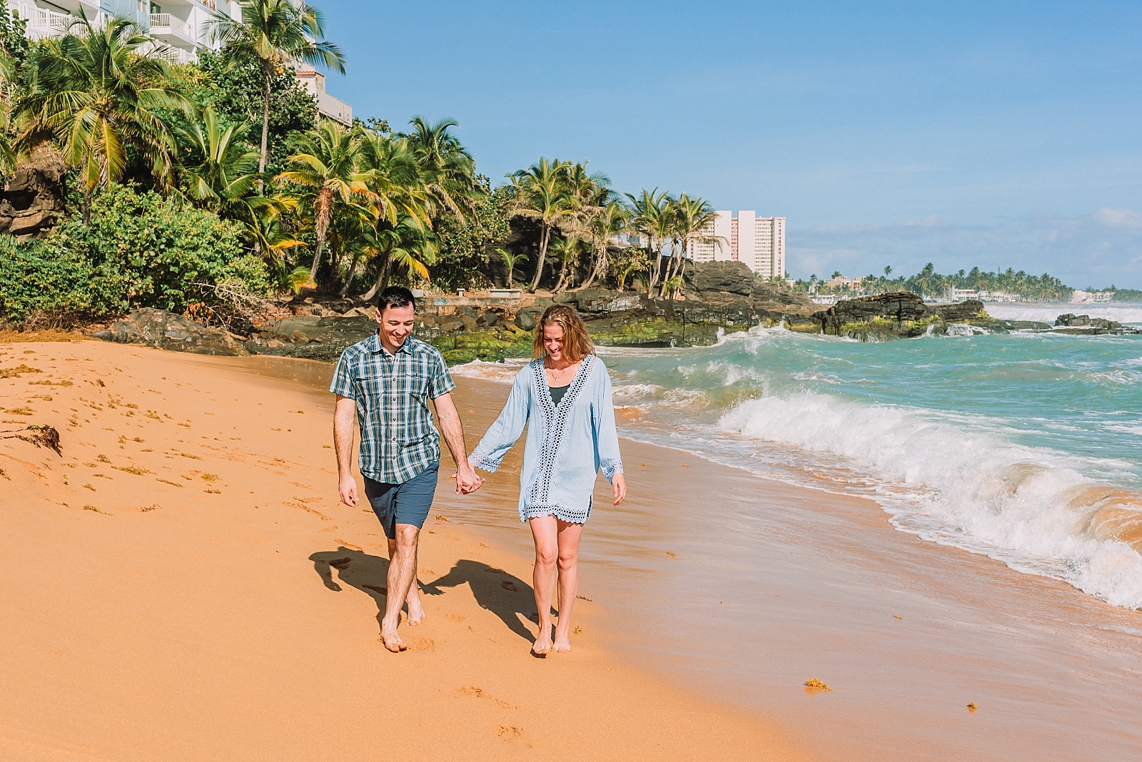 couple walks on the beach, posing ideas for engagements