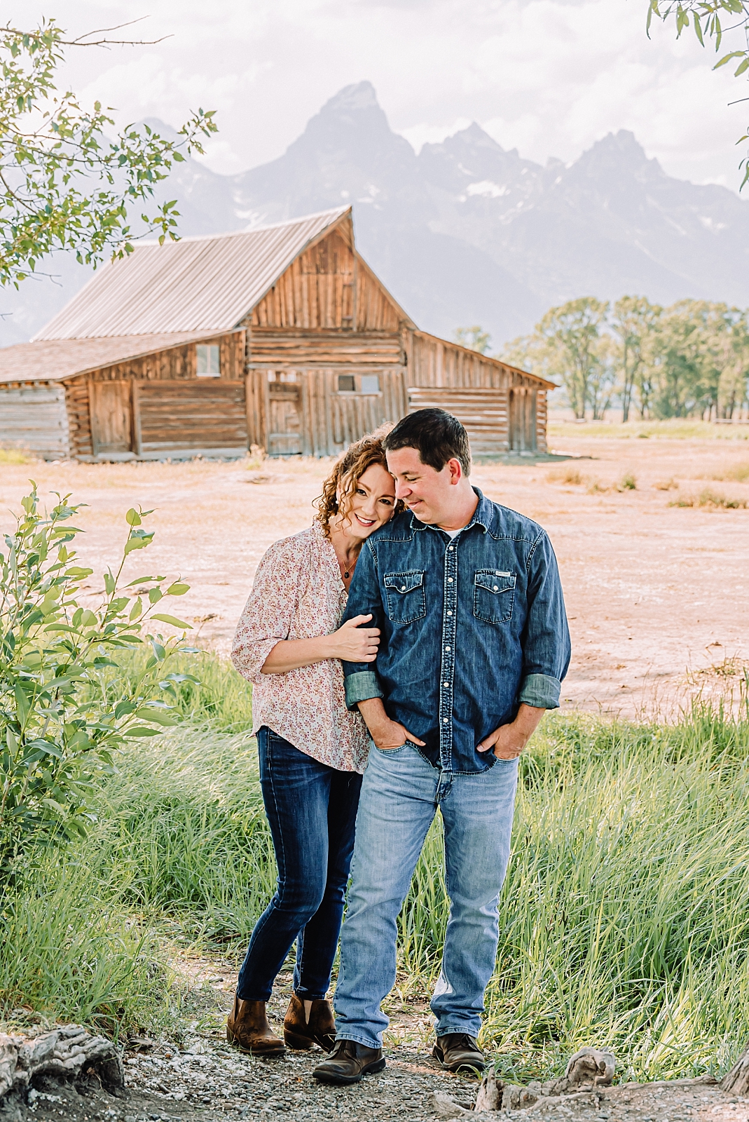 couple posing by the TA MOULTON BARN in Jackson Wy