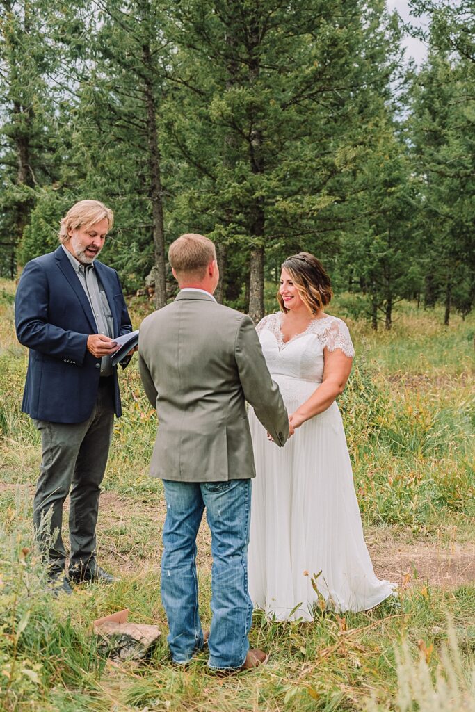couple shares vow during 10 year anniversary vow renewal at wedding tree in jackson hole