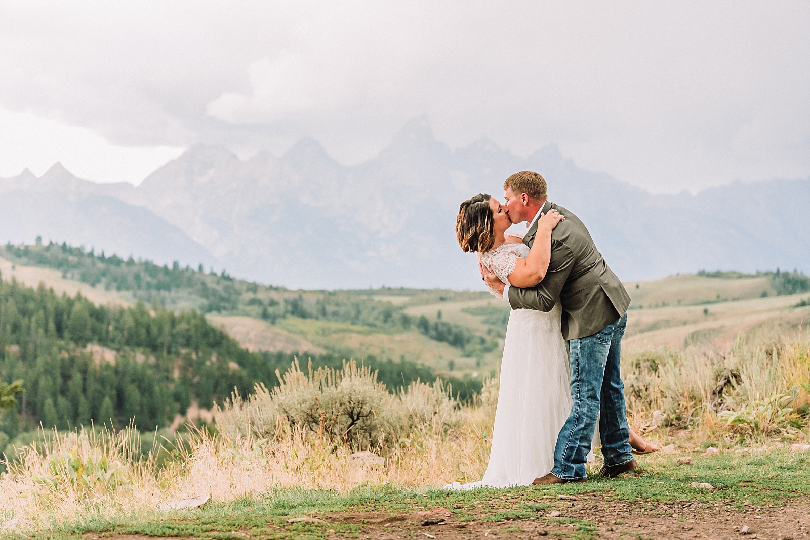 couple kisses in front of the teton mountain range during elopement