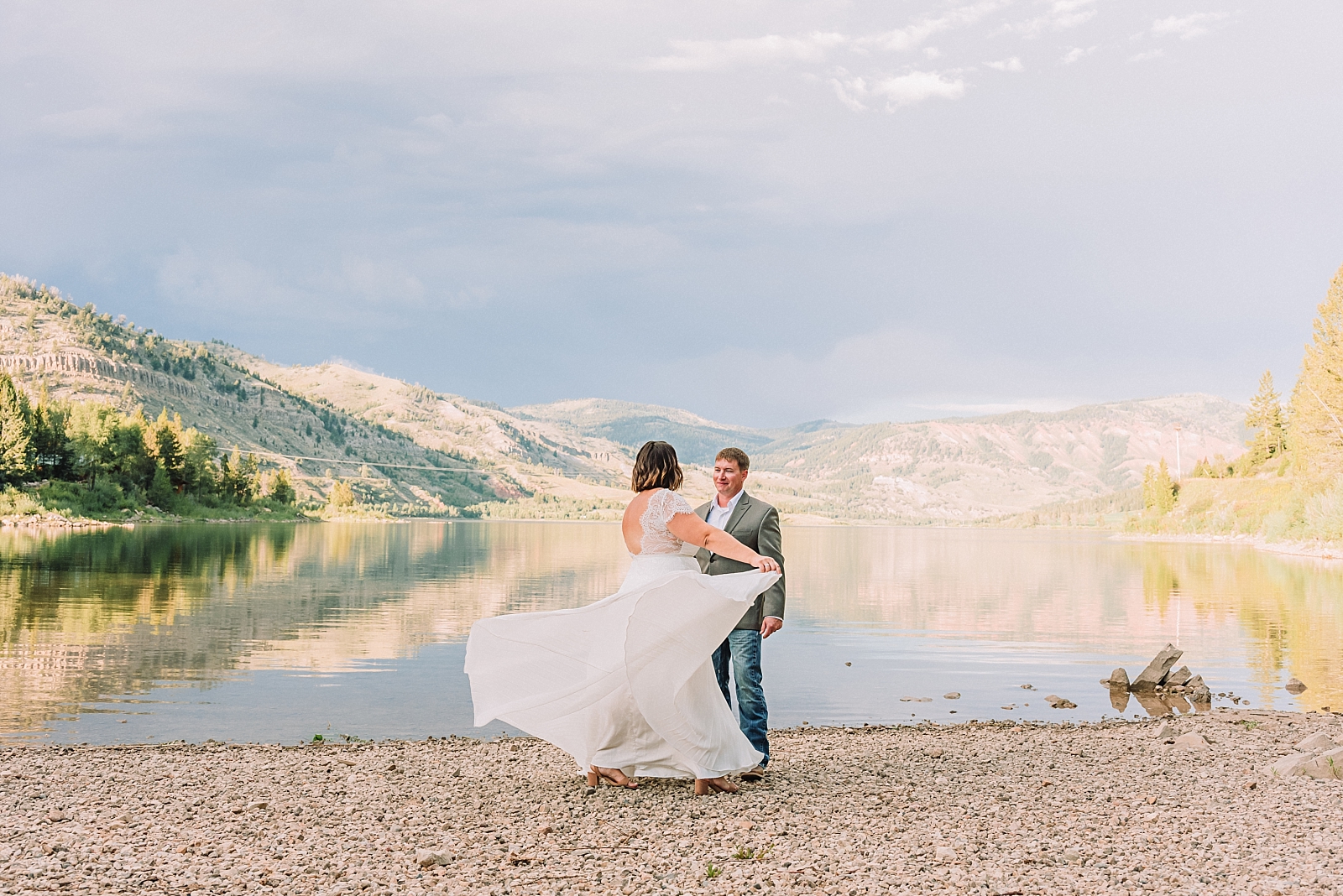 married couple dances along the lake shore in jackson hole wyoming wedding