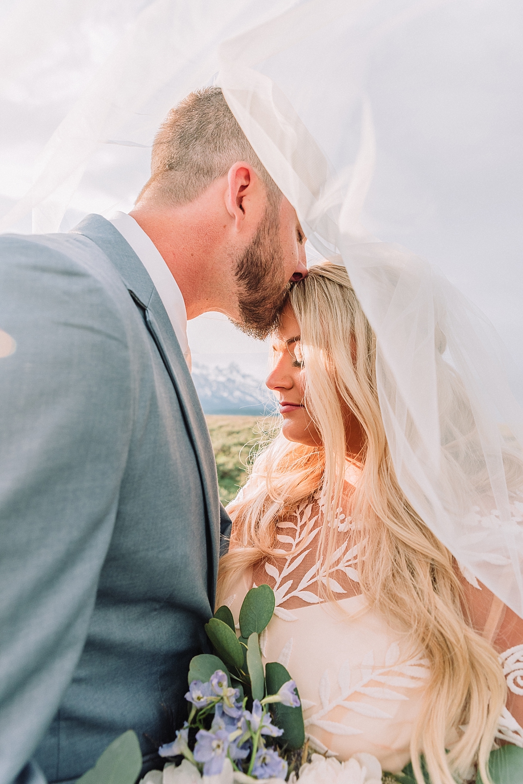 bride and groom kiss under the veil, teton weddings, jackson hole weddings