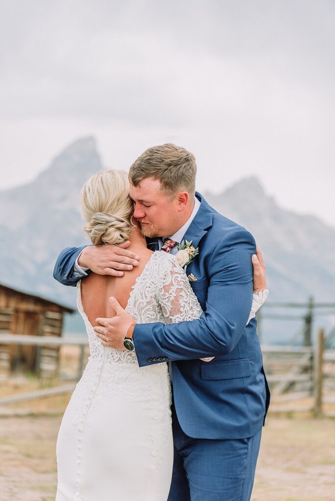 first look at mormon row between bride and groom, fall wedding ceremony, rainy wedding day, intimate elopement in the tetons