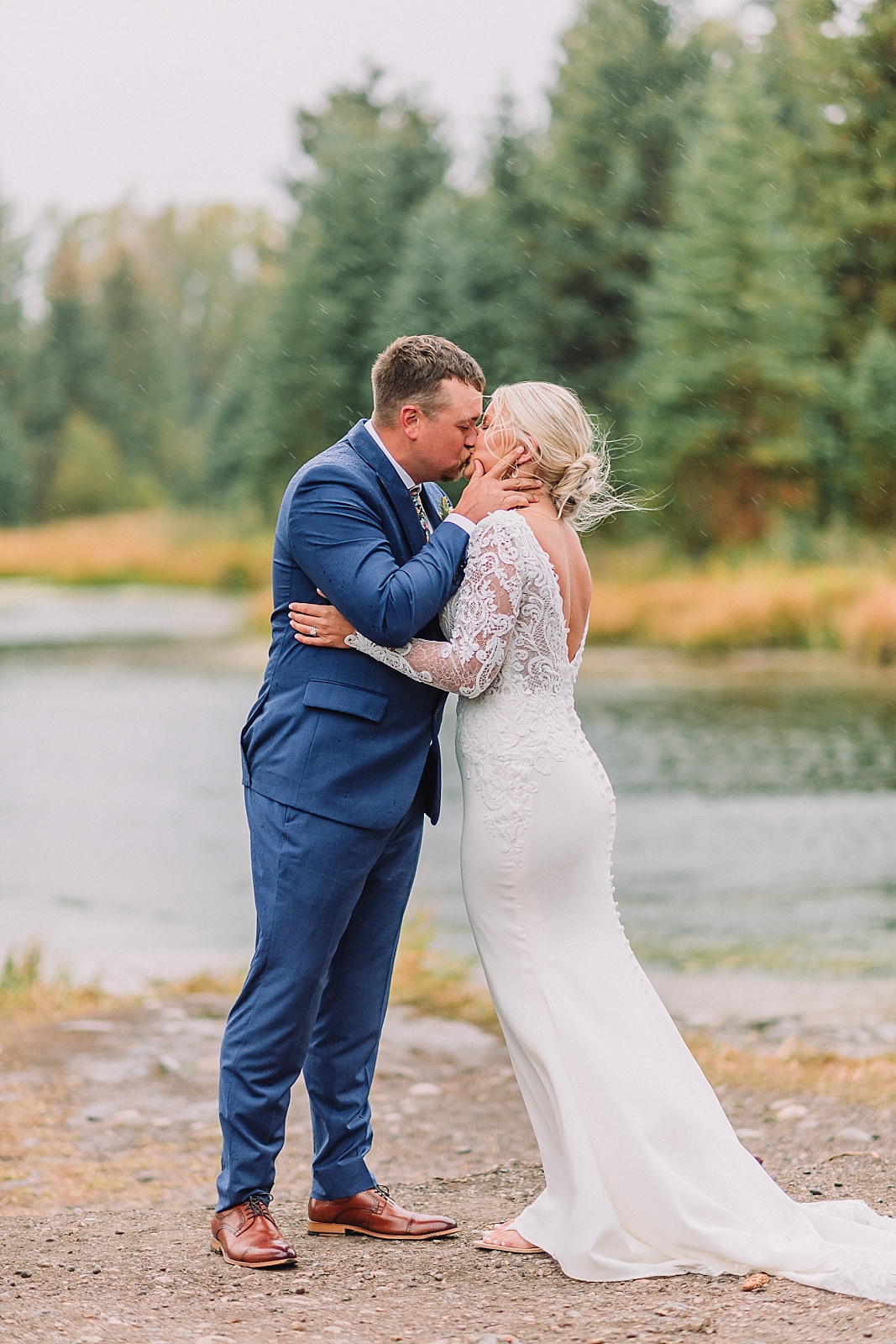 first kiss at Jackson Hole Small Wedding, Rainy wedding ceremony at Schwabacher's Landing, Grand Teton National Park Wedding, Elopement photos