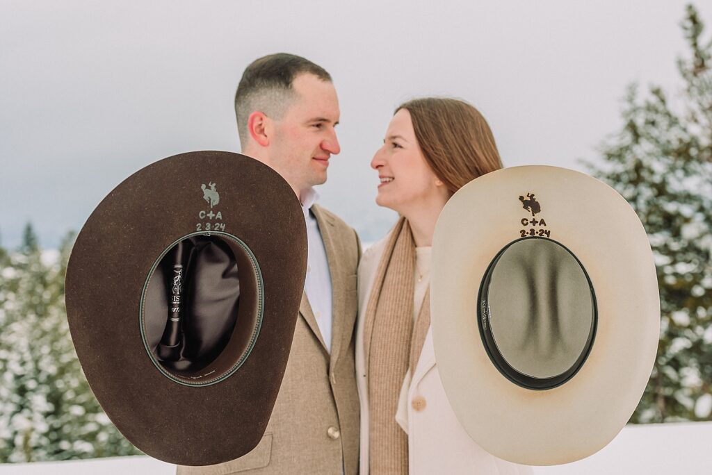 winter wedding photos with custom stamped cowboy hats