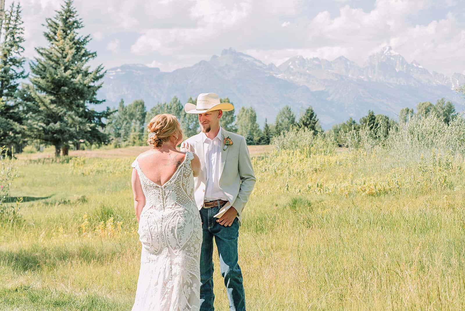 first look on wedding day between bride and groom in the mountains