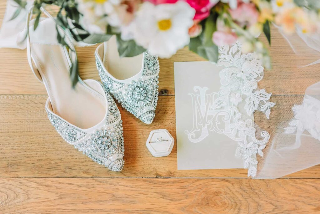 Jackson Hole Wedding Details, monogrammed wedding invitation, lace edged veil, studded shoes