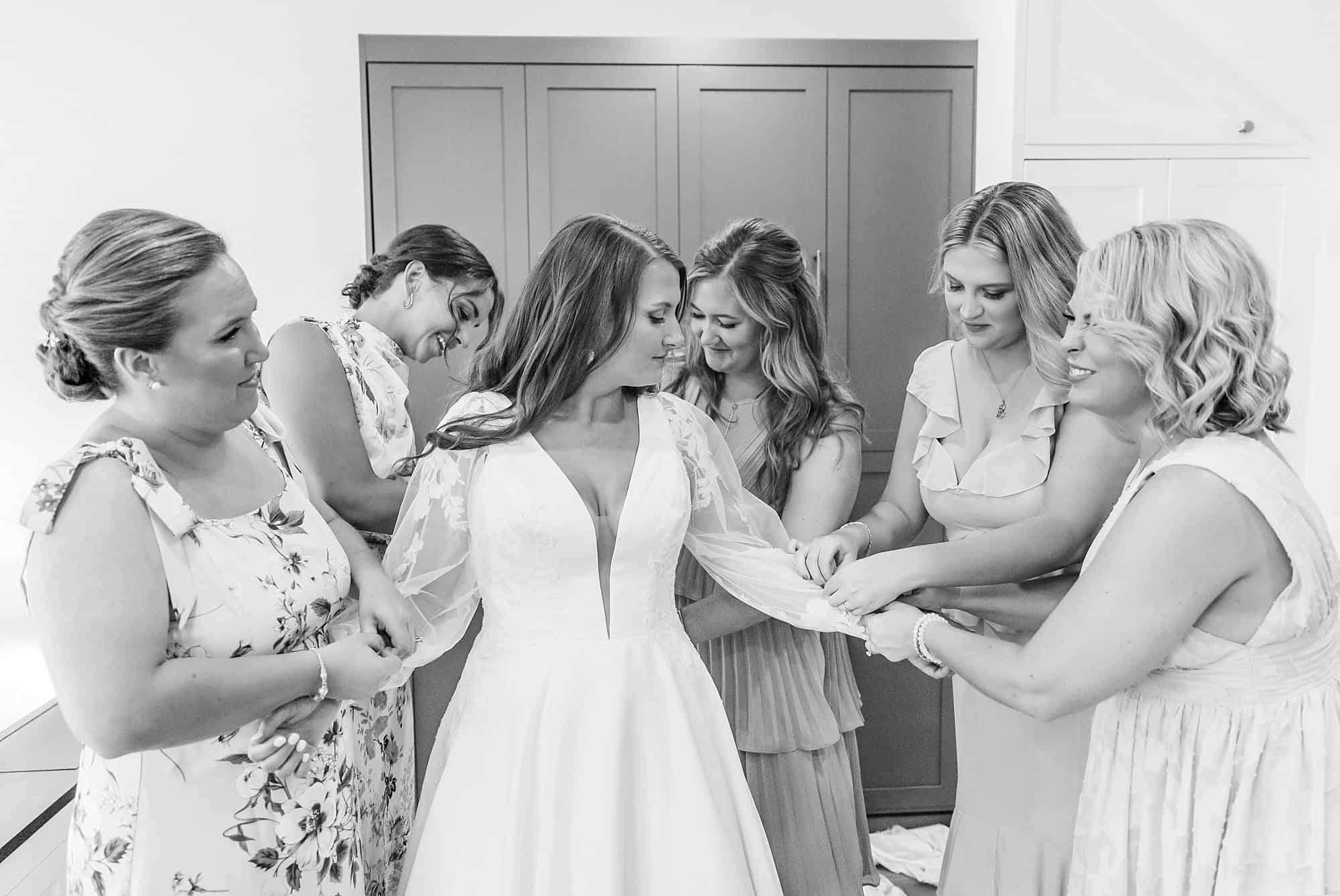 Bride gets ready for wedding with her bridesmaids