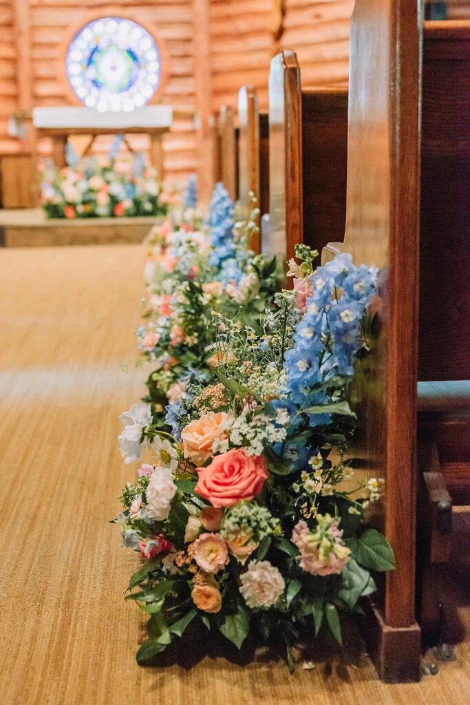 Chapel of the Sacred Heart wedding ceremony floral arrangements by Eden Flower Farm