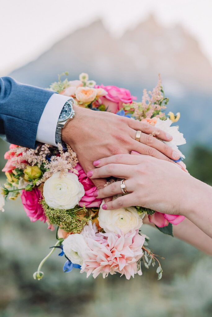 wedding flowers and bouquet with rings Grand Teton Elopement Photographer romantic wedding dresses outdoor wedding small intimate wedding ideas mountain wedding nature wedding timeless wedding classy wedding elopement elopement photography destination wedding Jackson Hole Wedding Photographer mountain view turnout wedding