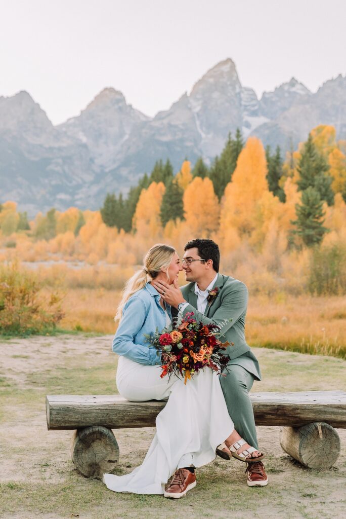 wedding couple posing in front of the grand teton mountains
