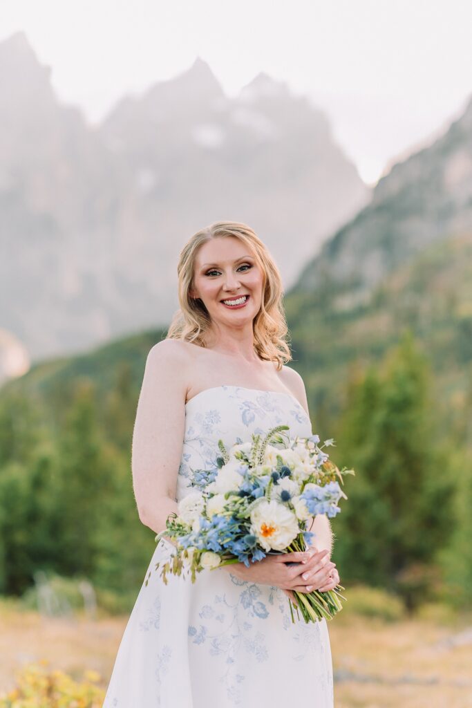 bride poses in wedding dress at String Lake in Jackson Hole