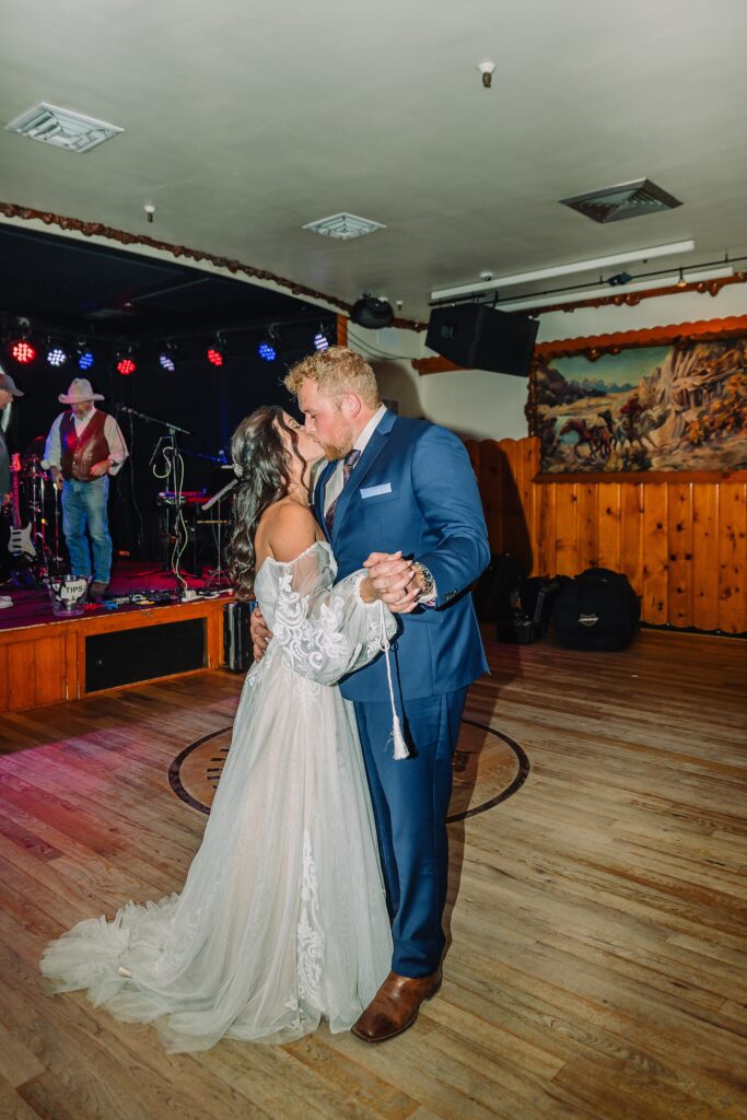 bride and groom dance at the million dollar cowboy bar in wyoming
