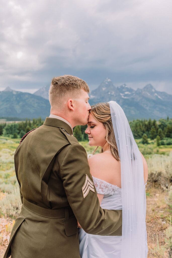 wedding couple poses eloping in jackson hole wyoming small wedding jackson hole summer wedding in grand teton national park snake river overlook wedding ceremony jackson hole wedding photographers blacktail ponds overlook