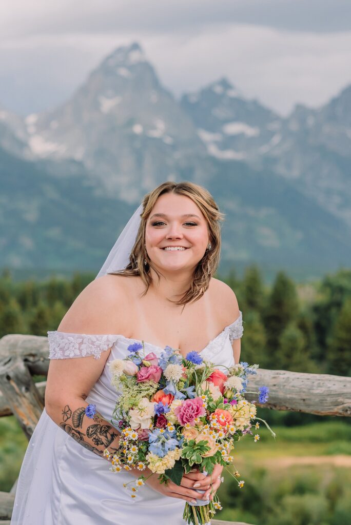 wedding couple poses eloping in jackson hole wyoming small wedding jackson hole summer wedding in grand teton national park snake river overlook wedding ceremony jackson hole wedding photographers blacktail ponds overlook