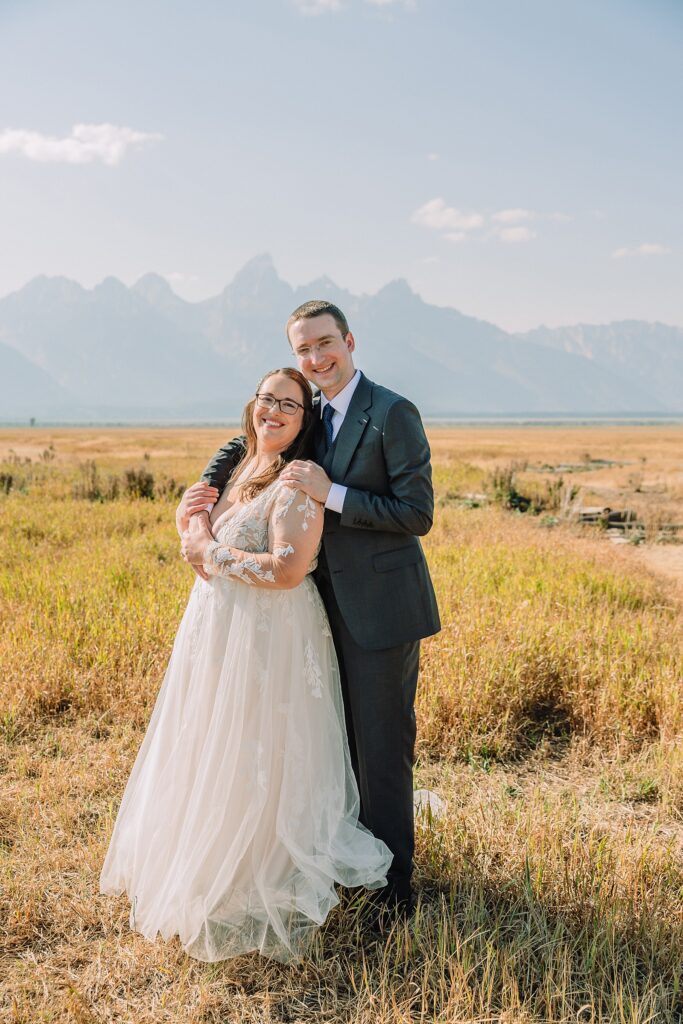 Mormon Row wedding portraits Jackson Hole bride in lace embroidered long sleeve wedding dress small intimate wedding ceremony ideas Mormon Row Grand Teton wedding ceremony