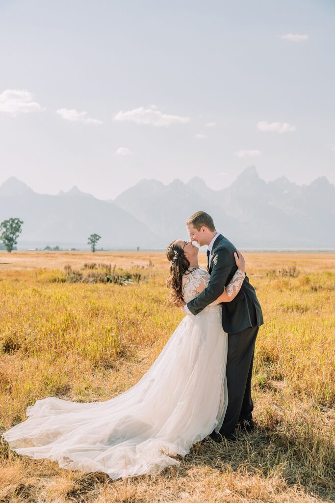Mormon Row wedding portraits Jackson Hole bride in lace embroidered long sleeve wedding dress small intimate wedding ceremony ideas Mormon Row Grand Teton wedding ceremony