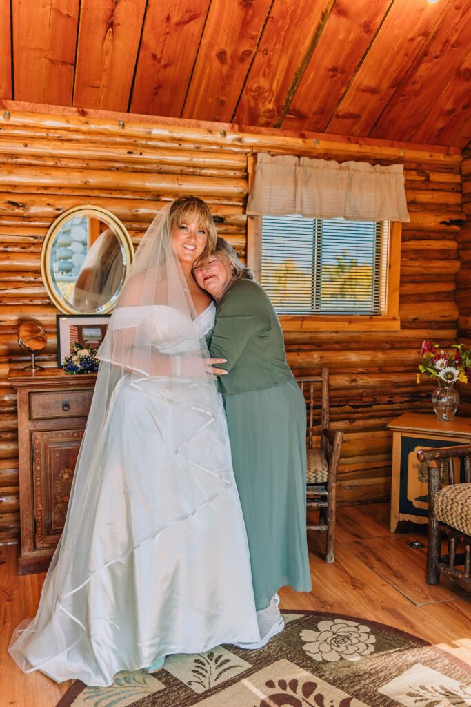 historic chapel wedding Wyoming mountains intimate wedding Chapel of the Transfiguration family photos Chapel of the Transfiguration wedding ceremony Grand Teton bride in mother's wedding dress teal boots fall wedding Chapel of the Transfiguration September Grand Teton National Park micro wedding
