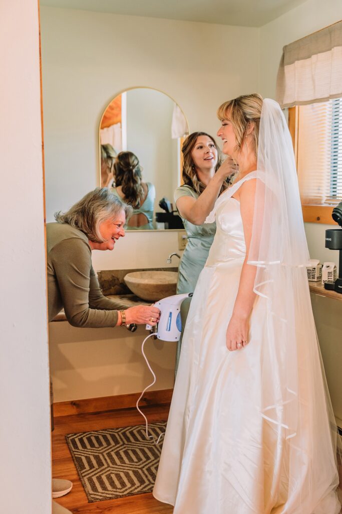 historic chapel wedding Wyoming mountains intimate wedding Chapel of the Transfiguration family photos Chapel of the Transfiguration wedding ceremony Grand Teton bride in mother's wedding dress teal boots fall wedding Chapel of the Transfiguration September Grand Teton National Park micro wedding bride in mother's wedding dress teal boots