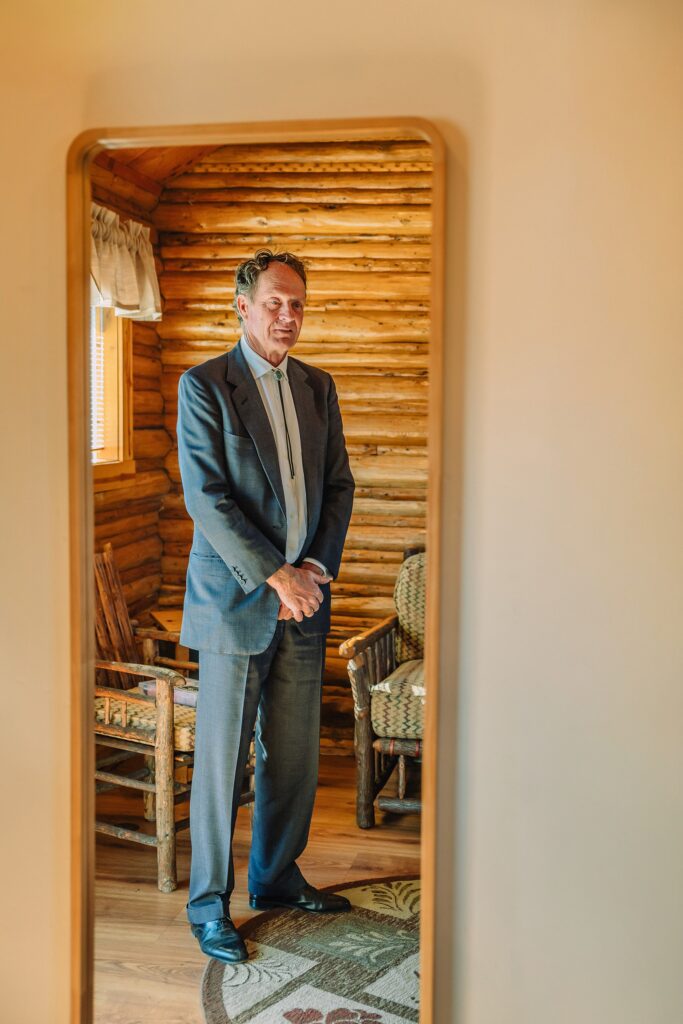 historic chapel wedding Wyoming mountains intimate wedding Chapel of the Transfiguration family photos Chapel of the Transfiguration wedding ceremony Grand Teton bride in mother's wedding dress teal boots fall wedding Chapel of the Transfiguration September Grand Teton National Park micro wedding bride in mother's wedding dress teal boots