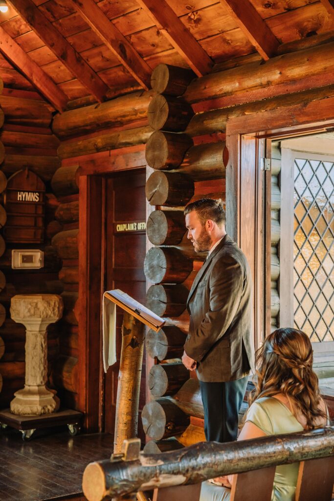 Grand Teton National Park micro wedding Chapel of the Transfiguration bride and groom portraits bride groom cowboy hat bolo tie mountain wedding Chapel of the Transfiguration bell ringing celebration Jackson Hole Wedding Photographers rustic chapel wedding log cabin ceremony