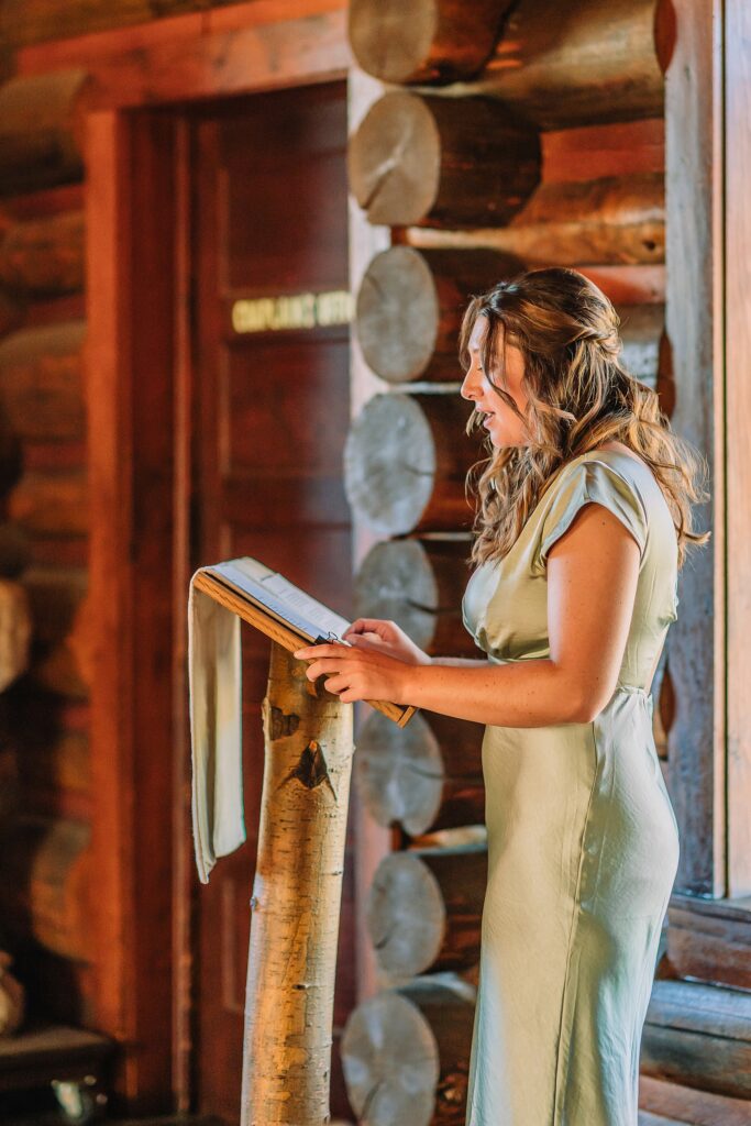 Grand Teton National Park micro wedding Chapel of the Transfiguration bride and groom portraits bride groom cowboy hat bolo tie mountain wedding Chapel of the Transfiguration bell ringing celebration Jackson Hole Wedding Photographers rustic chapel wedding log cabin ceremony