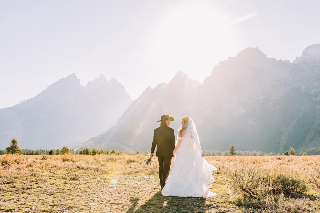 bride in mother's wedding dress teal boots bride groom cowboy hat bolo tie mountain wedding Cathedral Group Turnout wedding photos sagebrush String Lake wedding photography sunset late September wedding Grand Teton fall foliage