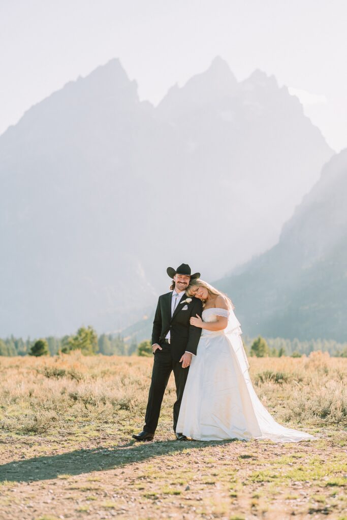 bride in mother's wedding dress teal boots bride groom cowboy hat bolo tie mountain wedding Cathedral Group Turnout wedding photos sagebrush String Lake wedding photography sunset late September wedding Grand Teton fall foliage