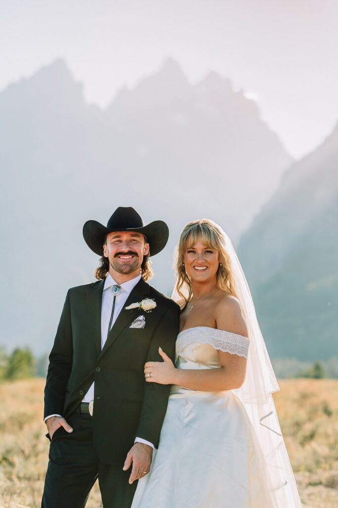 bride in mother's wedding dress teal boots bride groom cowboy hat bolo tie mountain wedding Cathedral Group Turnout wedding photos sagebrush String Lake wedding photography sunset late September wedding Grand Teton fall foliage