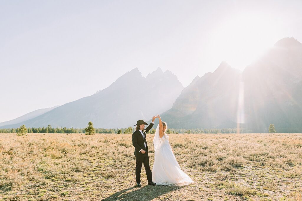 bride in mother's wedding dress teal boots bride groom cowboy hat bolo tie mountain wedding Cathedral Group Turnout wedding photos sagebrush String Lake wedding photography sunset late September wedding Grand Teton fall foliage