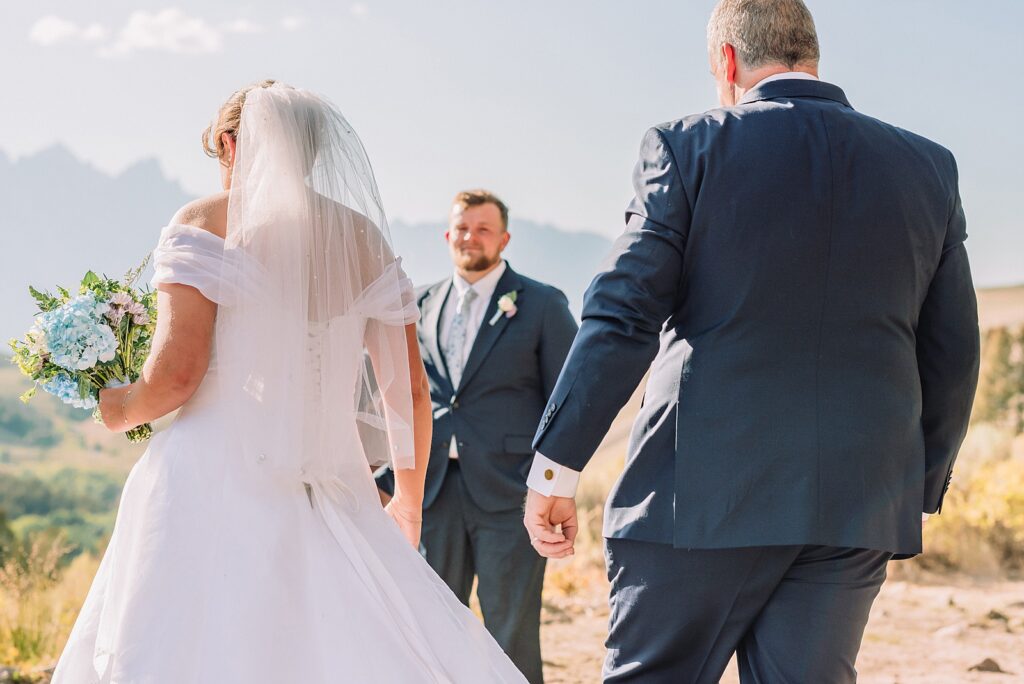 The Wedding Tree ceremony photos Wyoming bride wearing mother's wedding dress mountain elopement with Teton backdrop small intimate wedding ceremony ideas intimate outdoor Wyoming wedding inspiration