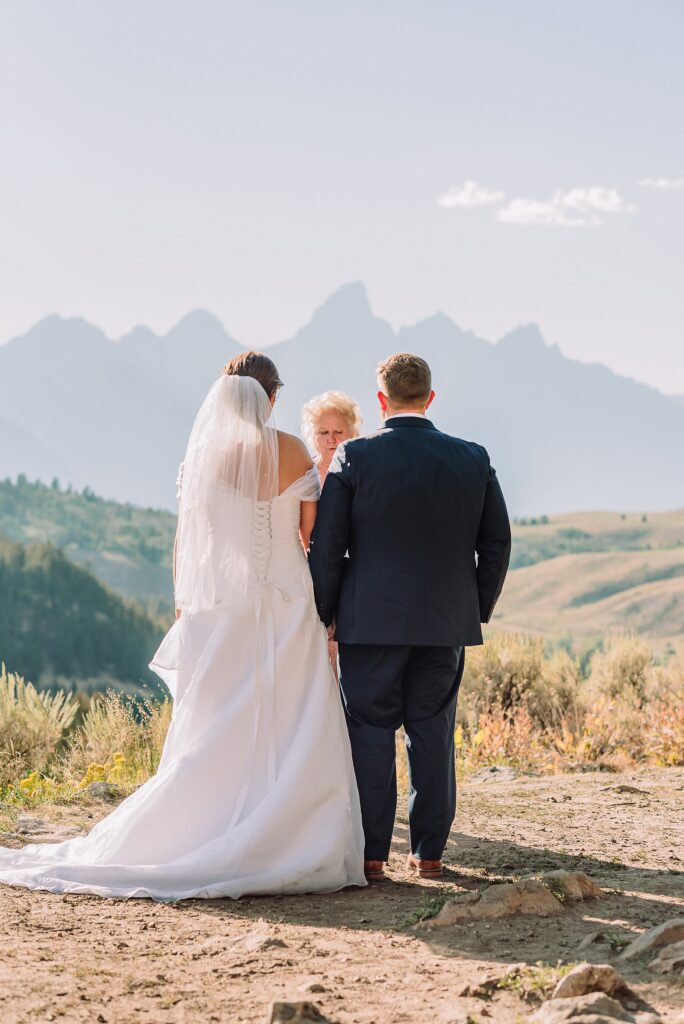 The Wedding Tree ceremony photos Wyoming bride wearing mother's wedding dress mountain elopement with Teton backdrop small intimate wedding ceremony ideas intimate outdoor Wyoming wedding inspiration