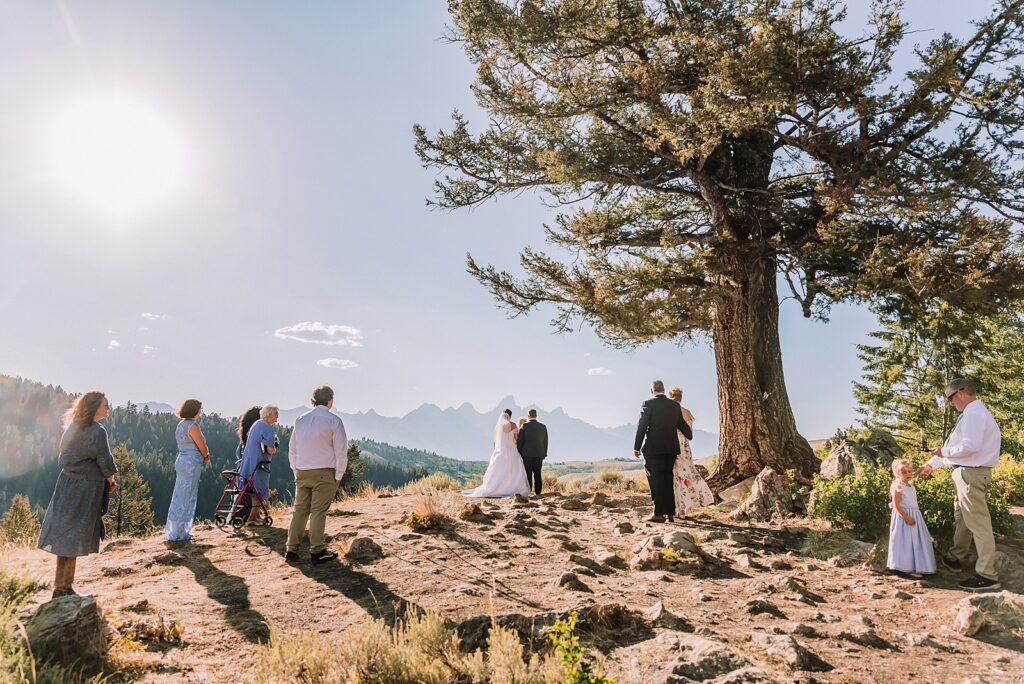 The Wedding Tree ceremony photos Wyoming bride wearing mother's wedding dress mountain elopement with Teton backdrop small intimate wedding ceremony ideas intimate outdoor Wyoming wedding inspiration