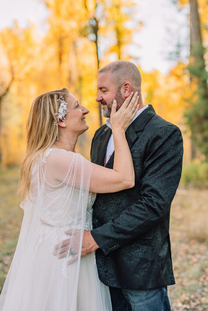 Jackson Hole honeymoon wedding photos Schwabacher Landing wedding portraits Snake River wedding photography September mountain wedding photos beaded wedding dress golden hour western groom style wedding photos Teton mountain wedding portraits sheer cape wedding dress photography