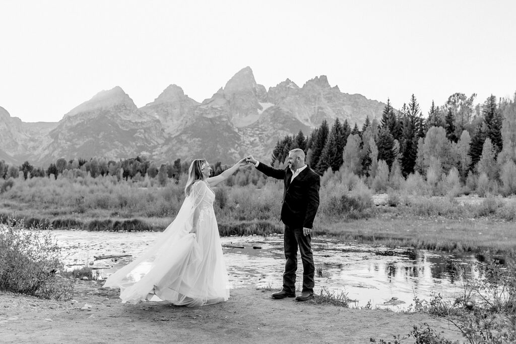 Jackson Hole honeymoon wedding photos Schwabacher Landing wedding portraits Snake River wedding photography September mountain wedding photos beaded wedding dress golden hour western groom style wedding photos Teton mountain wedding portraits sheer cape wedding dress photography