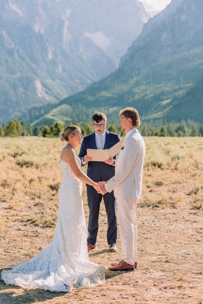 Cathedral View Turnout elopement ceremony Grand Teton National Park bride on horse Grand Teton elopement couple running down road Grand Teton elopement Jackson Hole micro wedding photographer how to get married in grand teton national park western wedding at Cathedral View Turnout horses in western wedding jackson hole