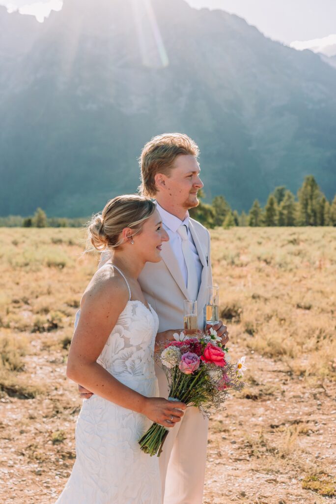 Cathedral View Turnout elopement ceremony Grand Teton National Park bride on horse Grand Teton elopement couple running down road Grand Teton elopement Jackson Hole micro wedding photographer how to get married in grand teton national park western wedding at Cathedral View Turnout horses in western wedding jackson hole