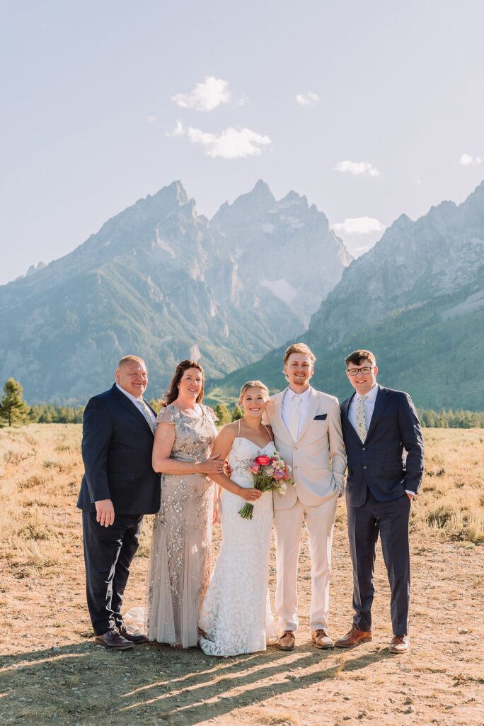 Cathedral View Turnout elopement ceremony Grand Teton National Park bride on horse Grand Teton elopement couple running down road Grand Teton elopement Jackson Hole micro wedding photographer how to get married in grand teton national park western wedding at Cathedral View Turnout horses in western wedding jackson hole